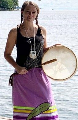 The lead artist and educator at Focal Point Artistry, Jessica Somers, embodying the roles of storyteller and cultural mentor through Indigenous Woodland style art.
